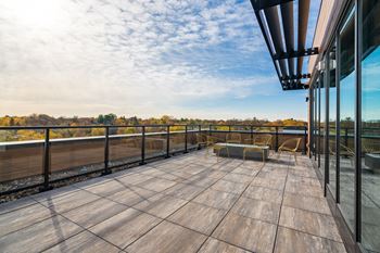 the deck of a condo with a table and chairs on it